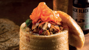 Chicken curry bunny chow with carrot-pickle