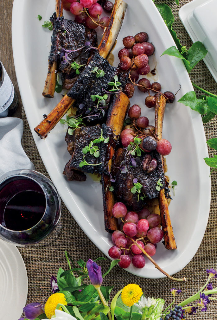Sticky beef ribs with grapes and olives