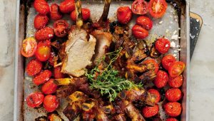 Slow-roasted pork crown with baby tomatoes